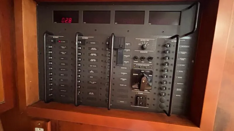 Wasabi Pea Yacht Photos Pics Electrical panel of a 2003 J Boats J/46 sailboat, featuring switches and controls.