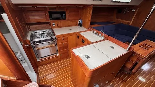 Wasabi Pea Yacht Photos Pics 2003 J Boats J/46 yacht interior with kitchen and seating area.