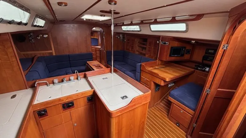 Wasabi Pea Yacht Photos Pics 2003 J Boats J/46 yacht interior with wood finish and blue seating.