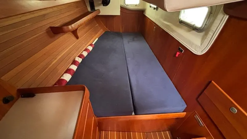 Wasabi Pea Yacht Photos Pics Interior cabin of 2003 J Boats J/46 with wooden paneling and blue cushions.