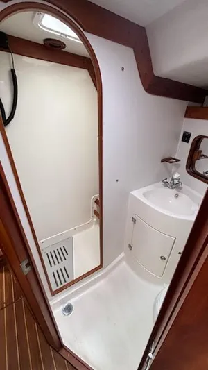Wasabi Pea Yacht Photos Pics 2003 J Boats J/46 yacht bathroom with shower, sink, and wooden accents.
