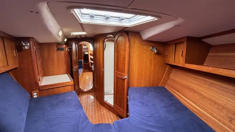 Wasabi Pea Yacht Photos Pics Interior of 2003 J Boats J/46 yacht with wooden finish and blue upholstery.