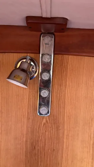 Wasabi Pea Yacht Photos Pics Interior detail of a 2003 J Boats J/46, featuring a wooden panel and metal fixture.