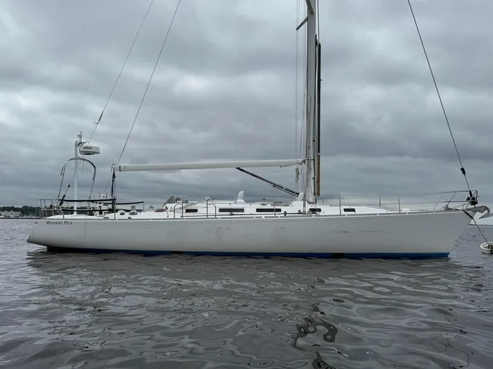 Wasabi Pea Yacht Photos Pics 2003 J Boats J/46 sailboat on calm water under cloudy skies.
