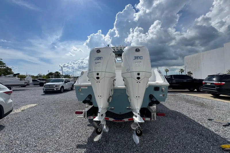  Yacht Photos Pics 2023 Sea Hunt Gamefish 30 Coffin Box with dual outboard engines in a parking lot.