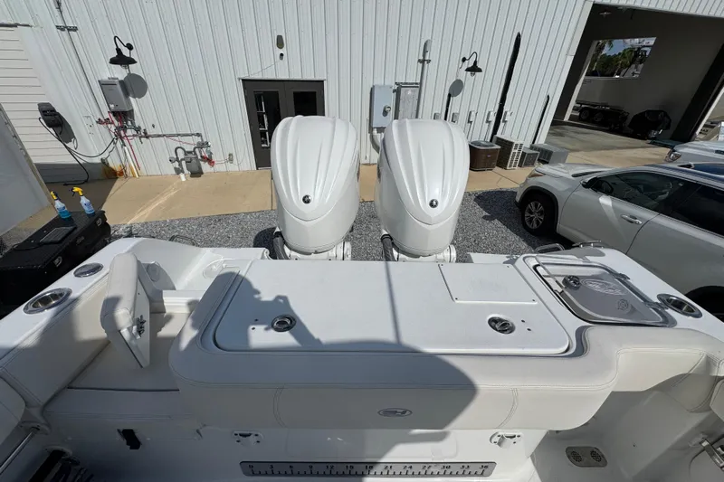  Yacht Photos Pics 2023 Sea Hunt Gamefish 30 Coffin Box boat with dual engines, docked near a building.