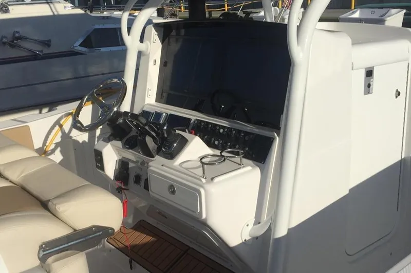 Yacht Photos Pics 2017 Southport 33 FE boat cockpit with steering wheel and control panel.
