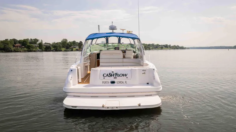  Yacht Photos Pics 1998 Sea Ray Sundancer 400 yacht on calm water, rear view with blue canopy.