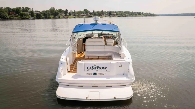  Yacht Photos Pics 1998 Sea Ray Sundancer 400 yacht with blue canopy on calm water.