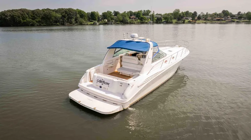  Yacht Photos Pics 1998 Sea Ray Sundancer 400 yacht with blue canopy on a calm lake.