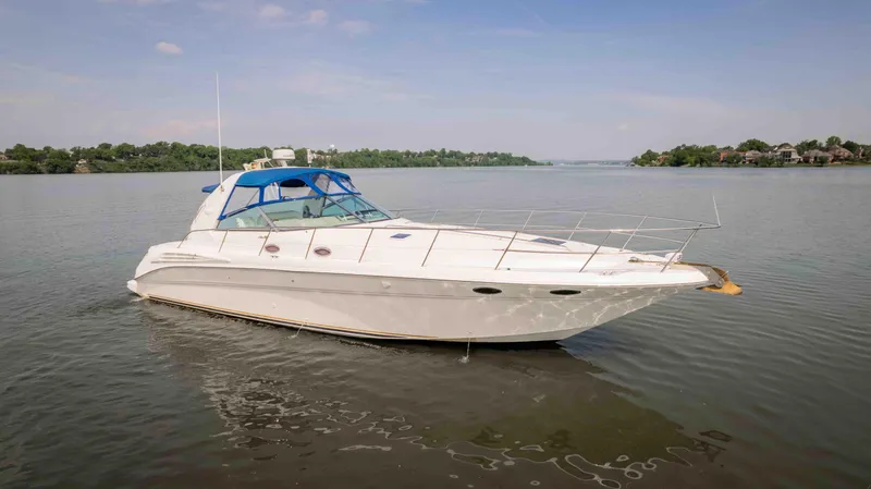  Yacht Photos Pics 1998 Sea Ray Sundancer 400 yacht on calm water, clear sky, distant shoreline.