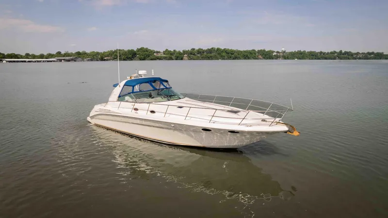  Yacht Photos Pics 1998 Sea Ray Sundancer 400 yacht on calm water, featuring a sleek design and blue canopy.