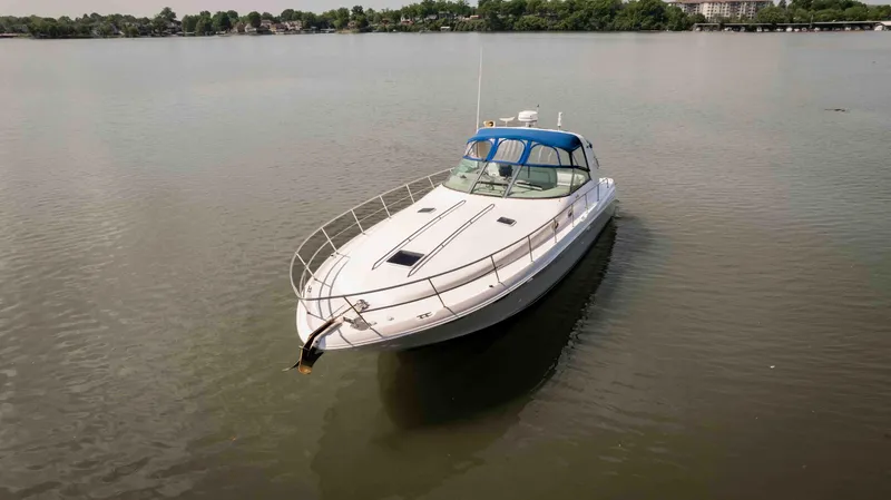  Yacht Photos Pics 1998 Sea Ray Sundancer 400 yacht on calm water, featuring sleek design and blue canopy.