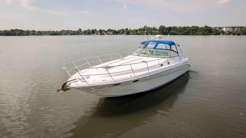  Yacht Photos Pics 1998 Sea Ray Sundancer 400 yacht on calm water with blue canopy.