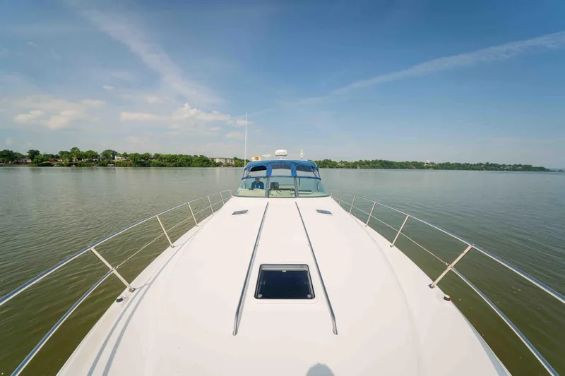  Yacht Photos Pics 1998 Sea Ray Sundancer 400 yacht cruising on calm waters under a clear blue sky.