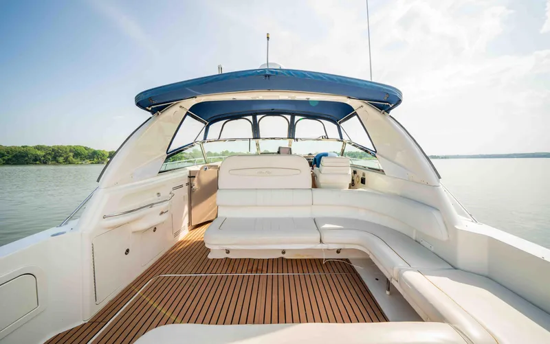  Yacht Photos Pics 1998 Sea Ray Sundancer 400 yacht with spacious deck and blue canopy on calm water.