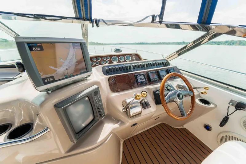  Yacht Photos Pics 1998 Sea Ray Sundancer 400 helm with navigation screens and wooden steering wheel.