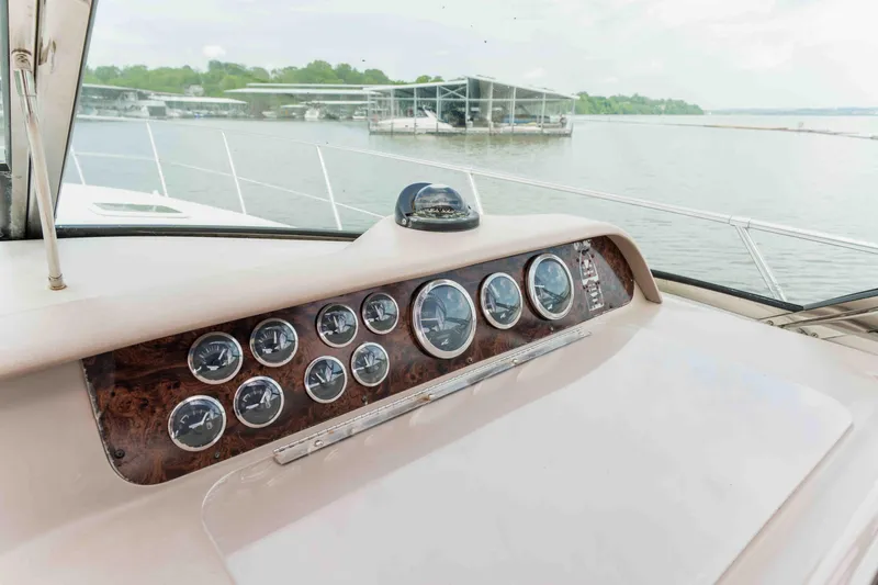  Yacht Photos Pics 1998 Sea Ray Sundancer 400 dashboard with gauges, overlooking a serene marina view.