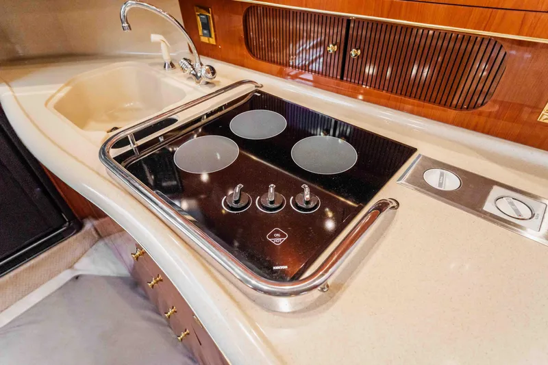  Yacht Photos Pics 1998 Sea Ray Sundancer 400 kitchen with stove and sink, featuring sleek design and modern amenities.