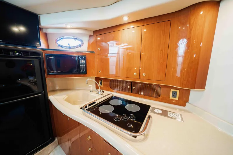  Yacht Photos Pics Luxurious kitchen interior of 1998 Sea Ray Sundancer 400 yacht with modern appliances.