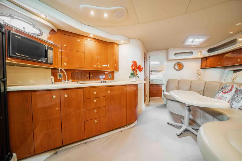  Yacht Photos Pics Luxurious interior of 1998 Sea Ray Sundancer 400 yacht with elegant wood cabinetry and seating.