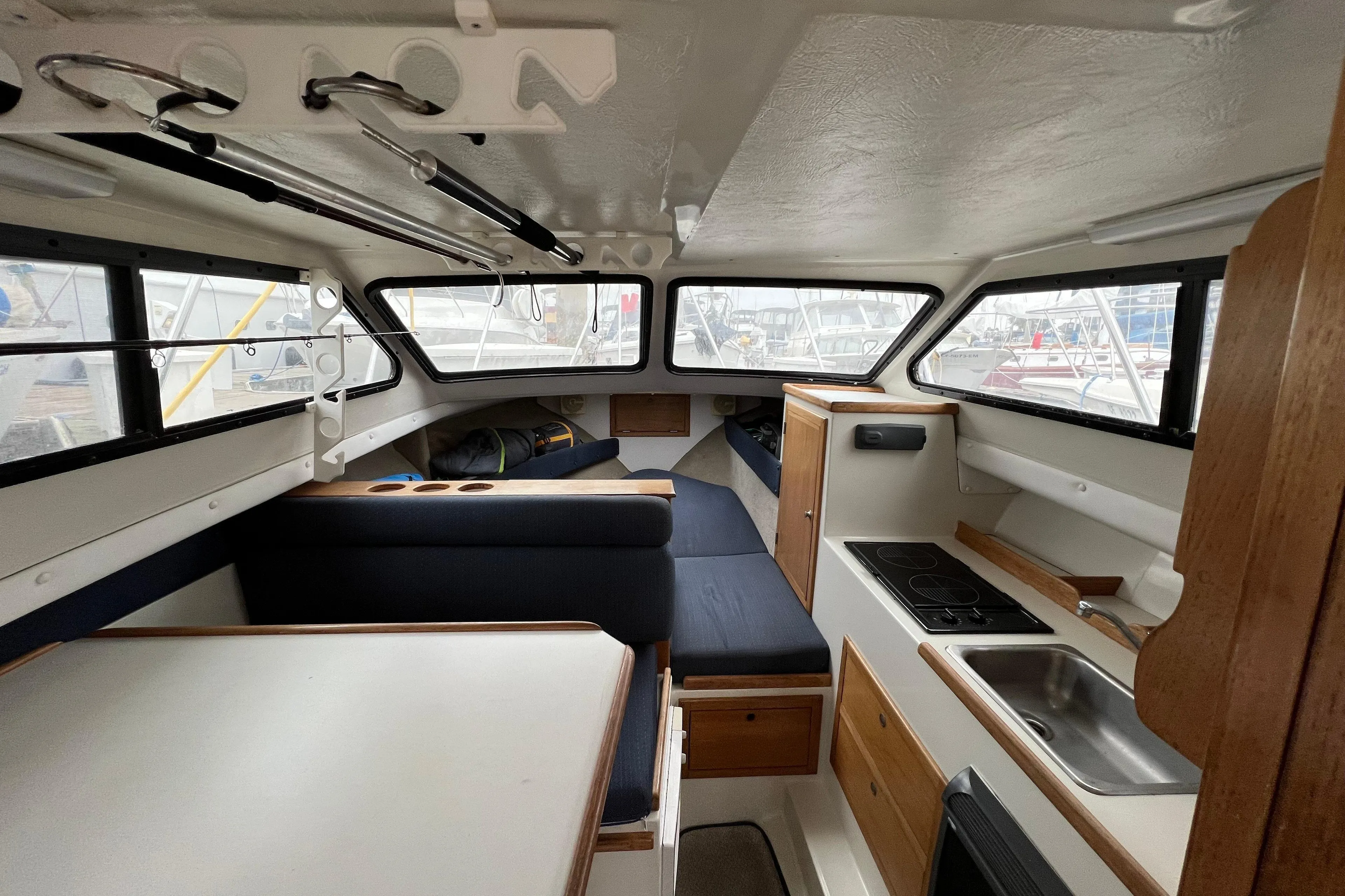 Interior of 2001 Skipjack 262 Flybridge boat with kitchenette and seating area.