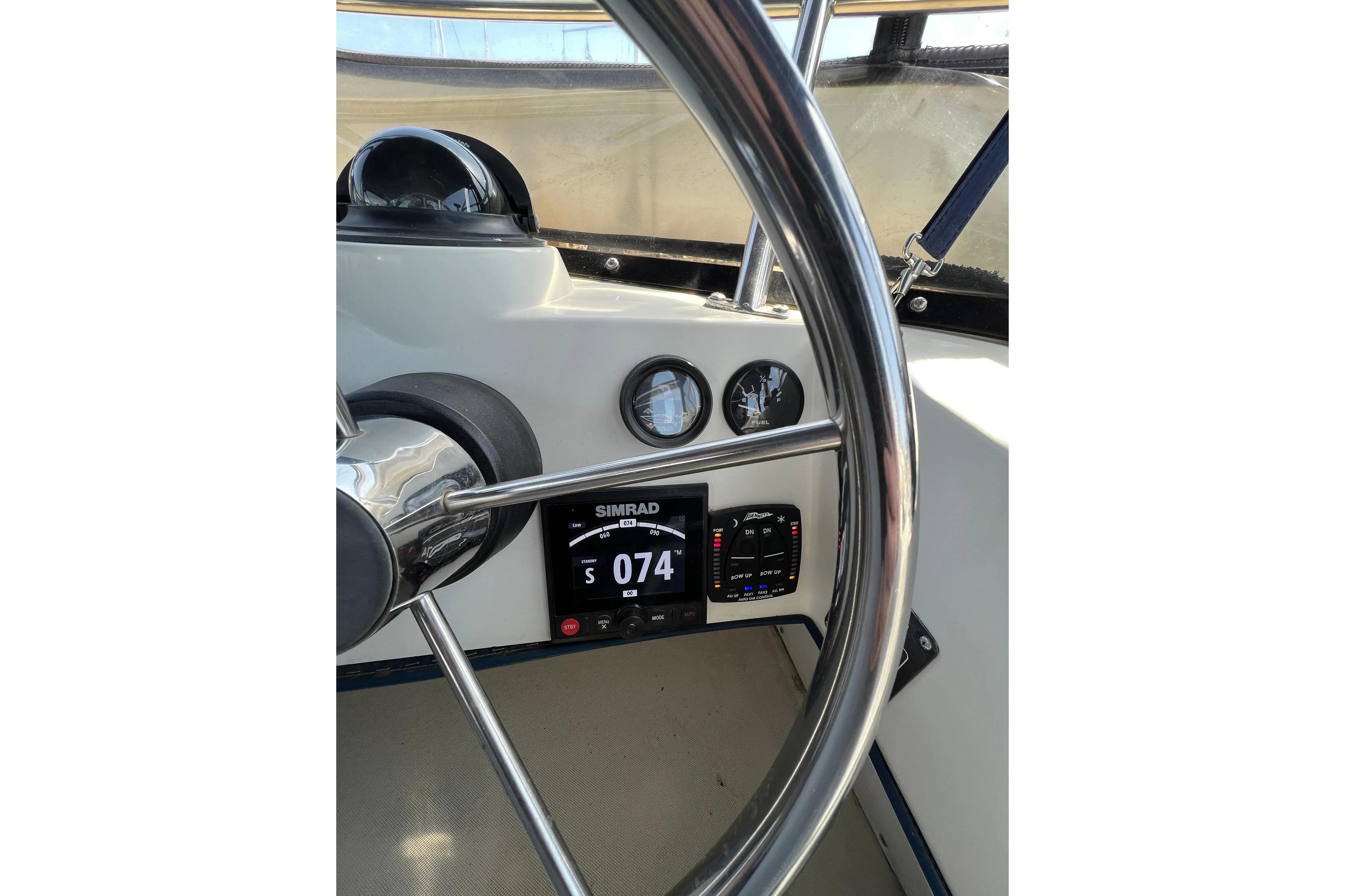 Steering wheel and dashboard of 2001 Skipjack 262 Flybridge boat with navigation instruments.