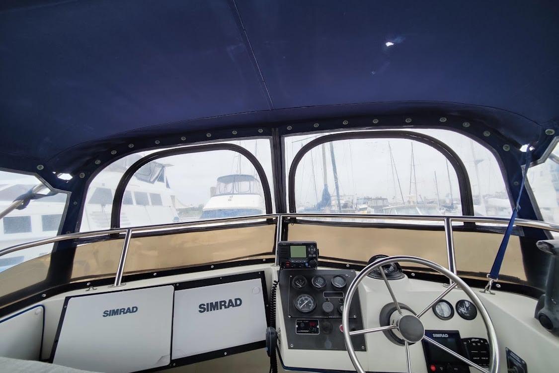 Interior view of 2001 Skipjack 262 Flybridge boat cockpit with navigation equipment.