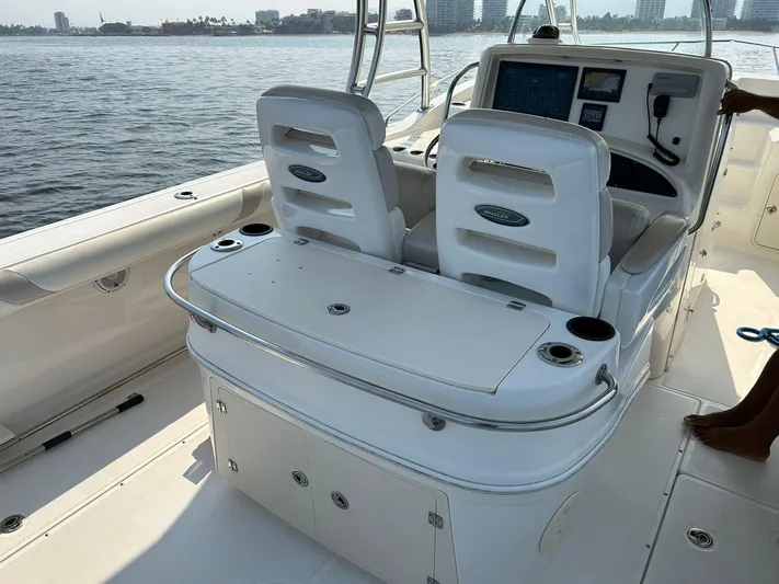 2009 Bw 320 Or Cc Yacht Photos Pics 2009 Boston Whaler 320 Outrage Cuddy Cabin interior with helm and seating, docked by the water.