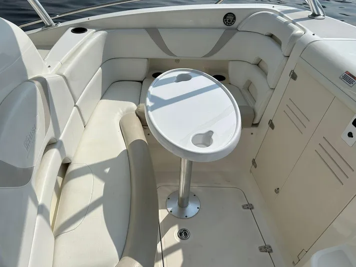 2009 Bw 320 Or Cc Yacht Photos Pics 2009 Boston Whaler 320 Outrage Cuddy Cabin interior with white seating and oval table.