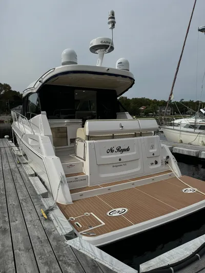 No Regrets Yacht Photos Pics 2020 Regal 38 Grande Coupe yacht docked, showcasing sleek design and spacious deck.