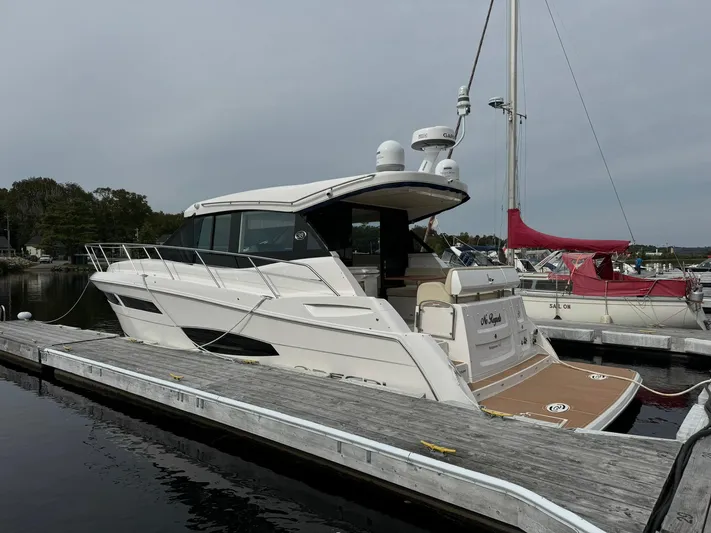 No Regrets Yacht Photos Pics 2020 Regal 38 Grande Coupe yacht docked at marina, side view.