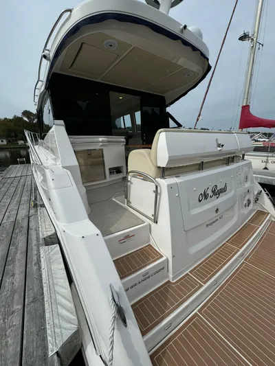 No Regrets Yacht Photos Pics 2020 Regal 38 Grande Coupe yacht docked, showcasing sleek design and spacious deck.