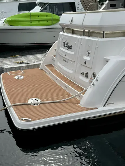 No Regrets Yacht Photos Pics 2020 Regal 38 Grande Coupe yacht docked, featuring a sleek rear deck design.