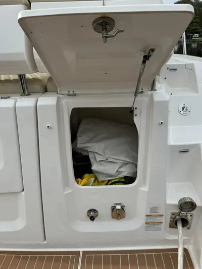 No Regrets Yacht Photos Pics 2020 Regal 38 Grande Coupe storage compartment with open hatch, showcasing interior space.