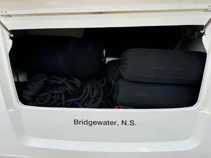 No Regrets Yacht Photos Pics Storage compartment of 2020 Regal 38 Grande Coupe, Bridgewater, N.S., with ropes and fenders.
