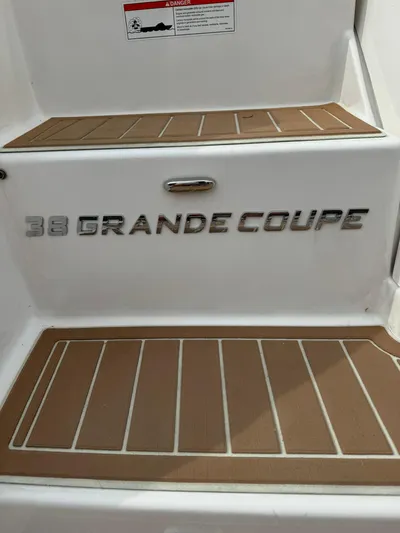 No Regrets Yacht Photos Pics 2020 Regal 38 Grande Coupe boat step with model name displayed.