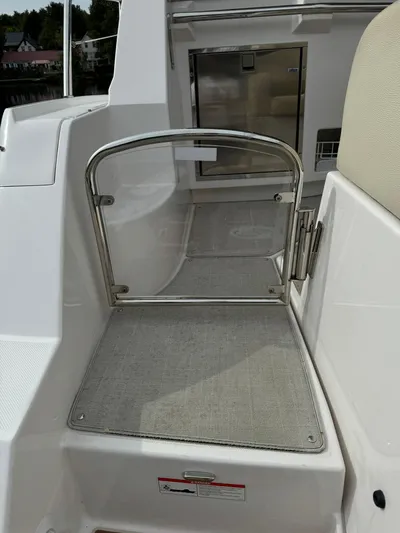 No Regrets Yacht Photos Pics 2020 Regal 38 Grande Coupe boat with stainless steel gate and cushioned seating area.