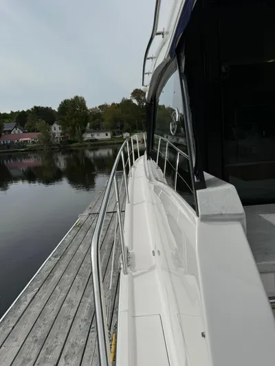 No Regrets Yacht Photos Pics 2020 Regal 38 Grande Coupe yacht docked by a serene lakeside.