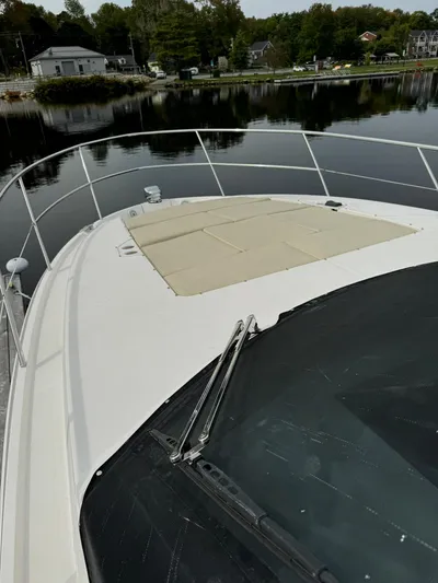 No Regrets Yacht Photos Pics 2020 Regal 38 Grande Coupe yacht on calm water, showcasing sleek deck design.