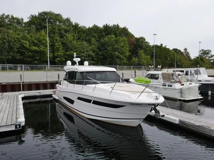 No Regrets Yacht Photos Pics 2020 Regal 38 Grande Coupe yacht docked at marina with lush green trees.