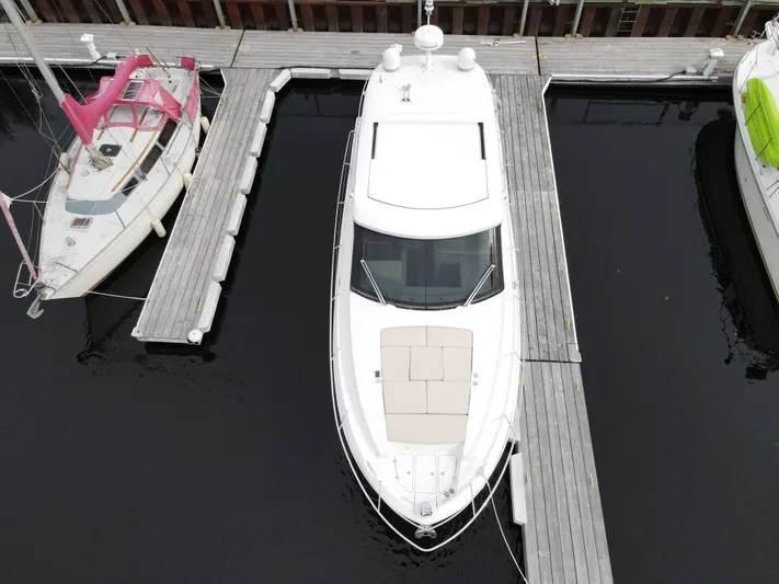 No Regrets Yacht Photos Pics Aerial view of a 2020 Regal 38 Grande Coupe docked at a marina.