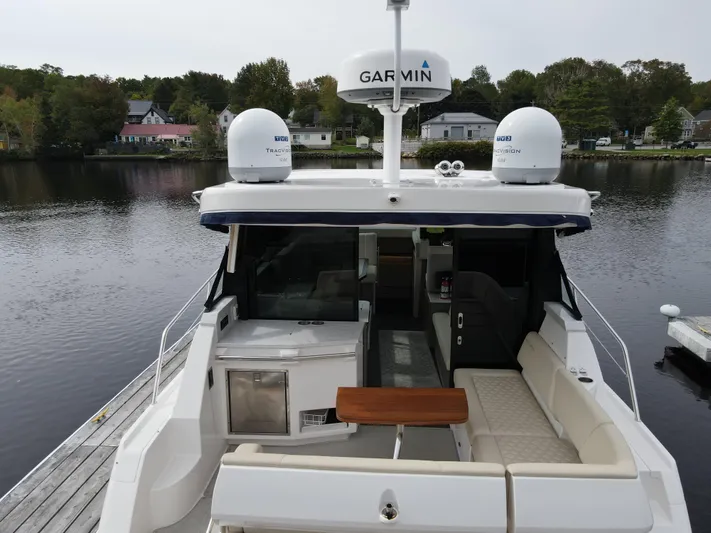 No Regrets Yacht Photos Pics 2020 Regal 38 Grande Coupe yacht docked by a serene lakeside.