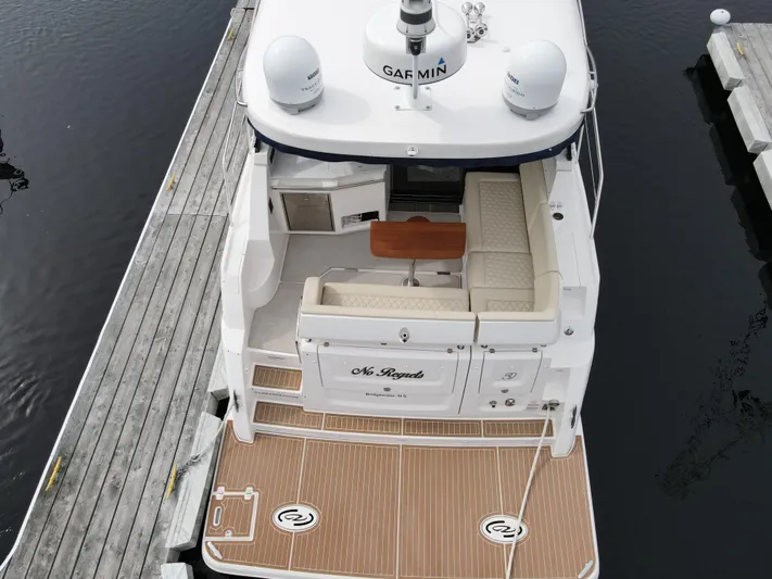 No Regrets Yacht Photos Pics 2020 Regal 38 Grande Coupe yacht docked, featuring spacious seating and modern design.