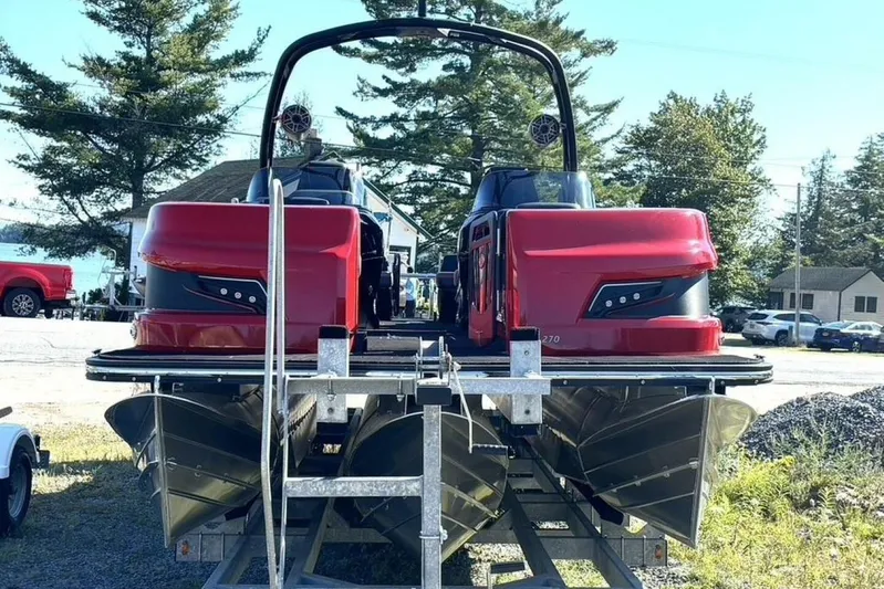  Yacht Photos Pics 2022 Manitou XT 27 SRW pontoon boat with red exterior, parked on a trailer.