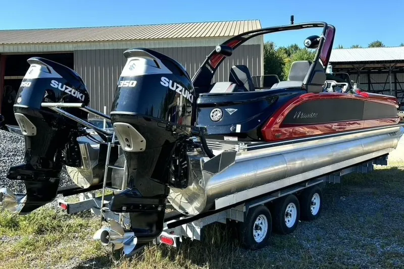  Yacht Photos Pics 2022 Manitou XT 27 SRW pontoon boat with dual Suzuki 350 engines on a trailer.