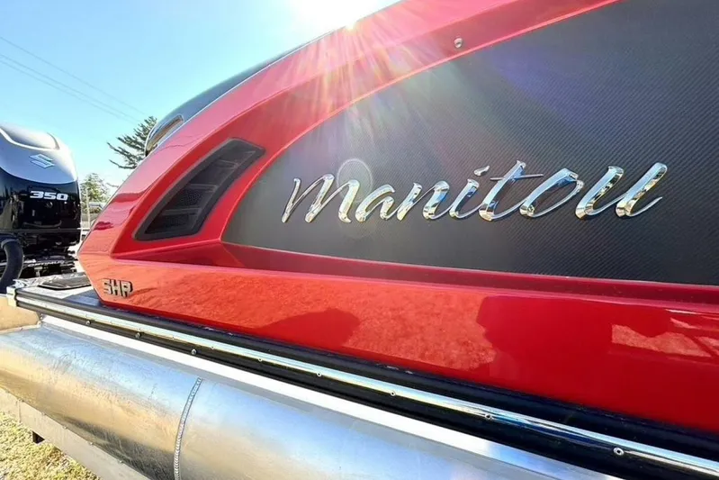  Yacht Photos Pics 2022 Manitou XT 27 SRW pontoon boat with sleek red design and Suzuki 350 engine.