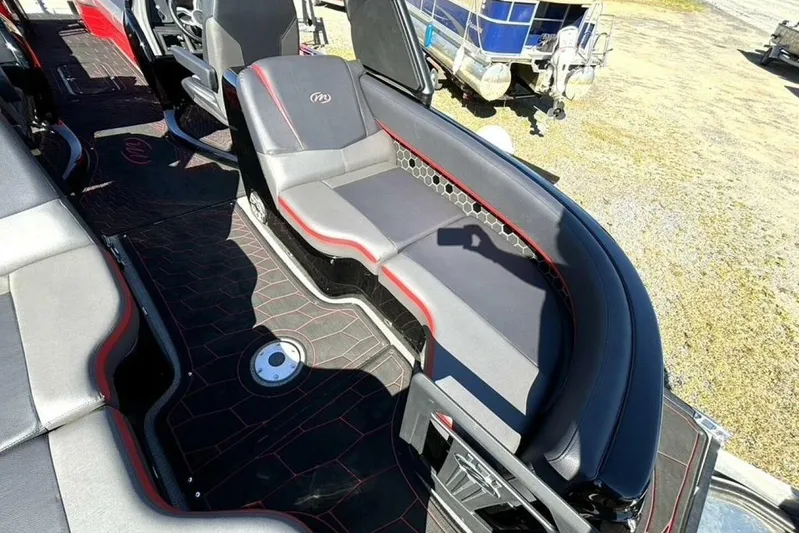  Yacht Photos Pics Luxurious seating on 2022 Manitou XT 27 SRW boat, featuring sleek black and red design.