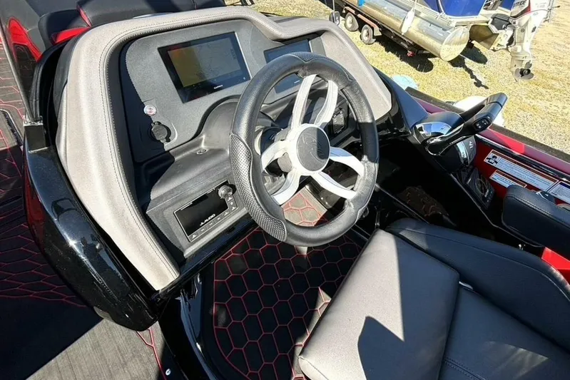  Yacht Photos Pics 2022 Manitou XT 27 SRW boat dashboard with steering wheel and control panel.