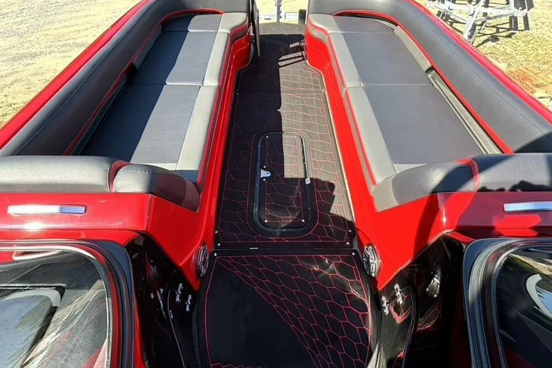  Yacht Photos Pics 2022 Manitou XT 27 SRW boat interior with red and black seating and flooring.